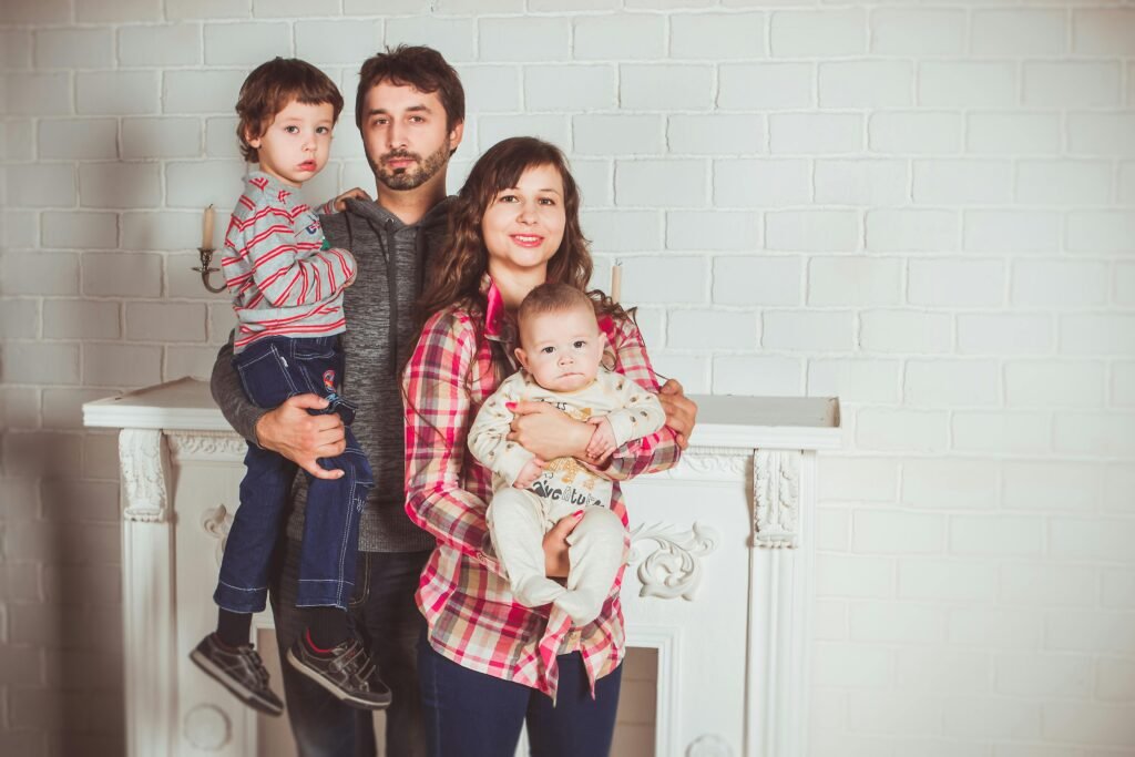 A joyful family posing together in a cozy living room, embodying love and togetherness.